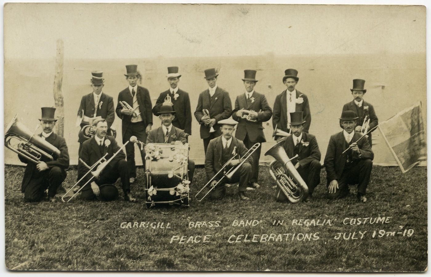 Coll. M Hymers
Peace Celebrations 1919.
rear J E Richardson, Edison Millican, ( died of anthrax, so the vicar wouldn't bury him in the graveyard- what a nice vicar!), Johnnie Currah, Robert Herdman, John Joseph Currah, Tom Willie Currah, Ralph Armstrong.
FrontJohn Wallace Millican of the George&Dragon Inn, Tom Currah, Matthew(Matt) Hetherington, T Cousin, or?Harry Armstrong , Hugh Millican, Wilfred Millican.
The band were not unfond of taking a drink- one young would-be musician being banned from joining for just that reason