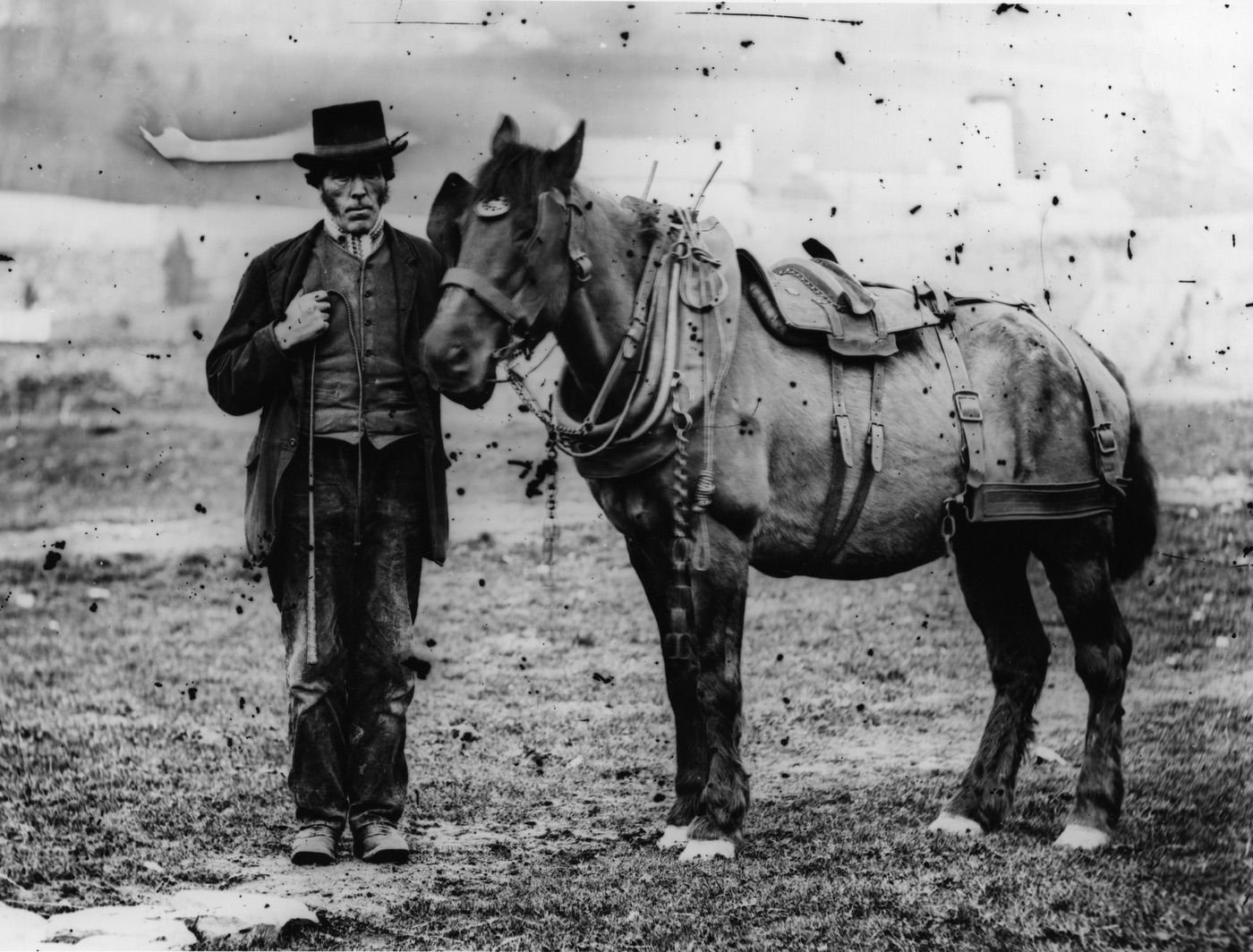Coll. AMHS. Man with horse/pony wearing "block cart" harness. Such harness was used until the 20's and beyond- for hauling lead ore.
Same background buildings as in Man with arthritic horse- a gently tapering short tower with a dark-rimmed top